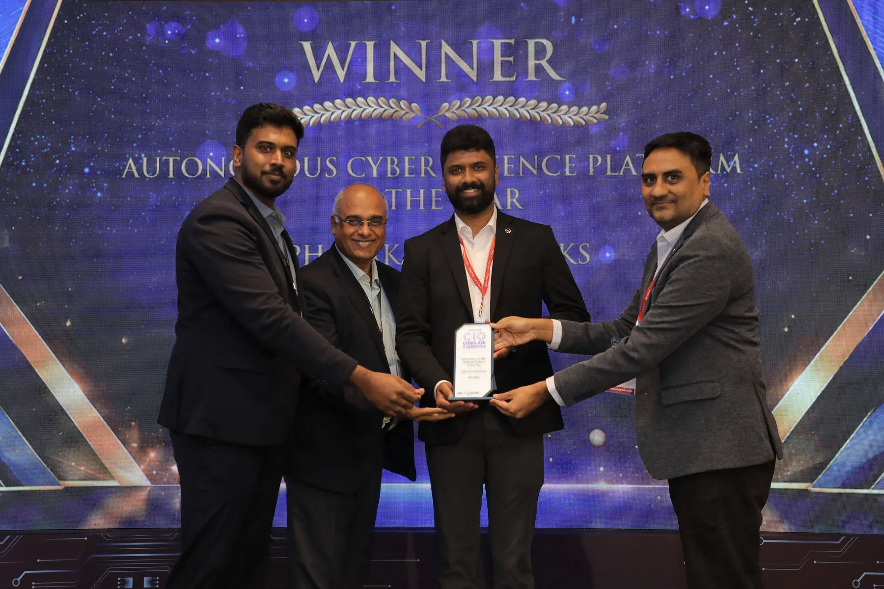 The Spharaka Networks team accepting the Autonomous Cyber Defence Platform of the Year award on stage at the 13th CIO Conclave and Awards 2026, with the winner screen behind them.